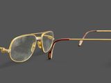 two pairs of glasses on a gray surface with a black background