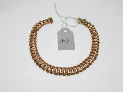 a gold chain bracelet with a price tag on it