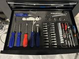 a drawer full of tools that are sitting on top of a table