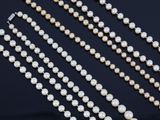a close up of a row of pearls on a black surface