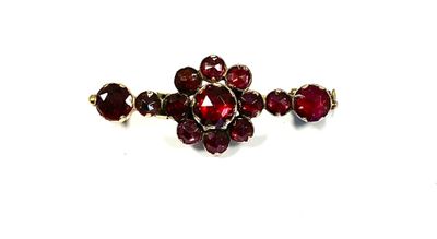 an image of a close up of a ring with red stones