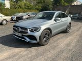 the mercedes gle is parked in a parking lot with other cars