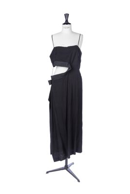 a black dress on a mannequin stand on a white background