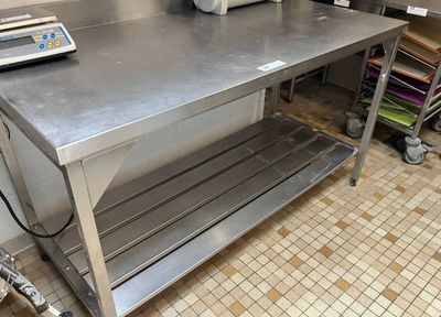 a stainless steel table with a scale on top of it