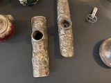 a lot of silver objects on display on a table