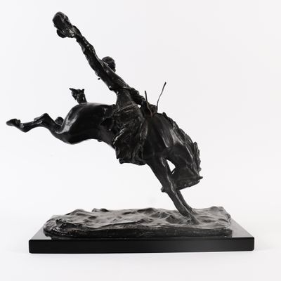 statue of a man riding a horse in the air with his foot in the air