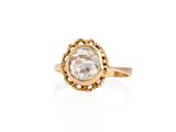 a gold ring with a white diamond in the center