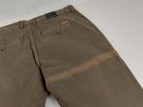 a close up of a pair of khaki pants on a white surface