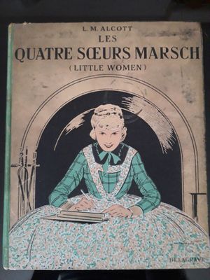 un vieux livre sur lequel figure l'image d'une femme assise à une table