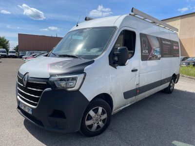 the white van is parked in the parking lot outside of the building