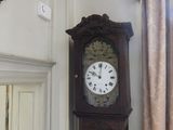 a grandfather clock that is in the corner of a room