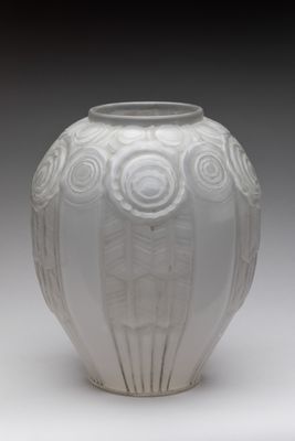 a white vase that is sitting on a table