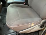 a picture of a dirty car seat with a broken arm rest