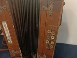 a brown accordion sitting on a blue surface