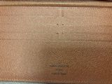 an image of a brown purse sitting on top of a wooden table