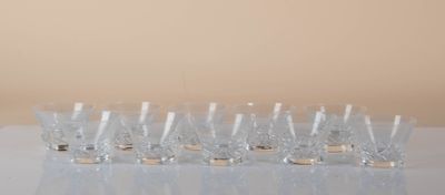 a lot of glasses sitting on a table next to each other