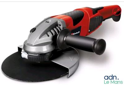 a close up of a red and black polisher on a white surface