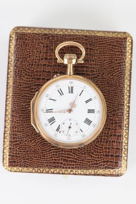 an image of a gold pocket watch with roman numerals on it