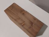 a wooden block sitting on a white table