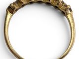 a close up of a gold ring on a white surface
