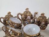 a group of teapots and cups sitting on a table
