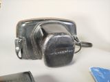 a camera and a cell phone sitting on a table