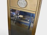 a mirror with a gold frame and a mirror with a clock on it