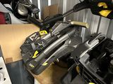 several skis and snowboards are lined up on a shelf in a storage room