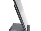 a phone that is sitting on a stand on a table