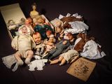 a pile of dolls and other items on a table