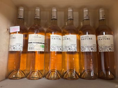 six bottles of wine in a cardboard box with labels on them