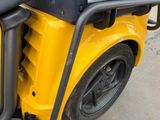 a close up of the front of a yellow vehicle