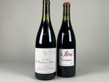 two bottles of wine sitting next to each other on a table