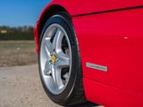 the red sports car is parked on the side of the road
