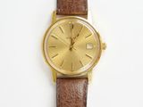 brown leather watch strap with a gold plated watch face on a white background