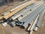 a pile of lumber sitting on the ground in a yard