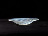 a glass bowl that is sitting on a black surface
