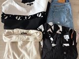 several pieces of clothing are laid out on a wooden floor
