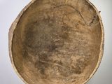 a brown bowl sitting on top of a white pedestal