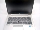 a laptop computer that is sitting on a white table