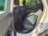 a car with the door open sitting in the back of the car