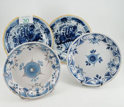 three blue and white plates with floral designs on them