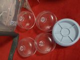 a blender and several empty glasses on a red table