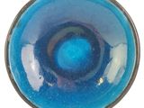 a close up of a blue bowl on a white surface