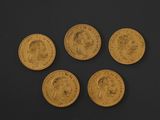 four gold sovereigns, one of which has a crown on it