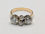 a close up of a diamond ring on a white surface