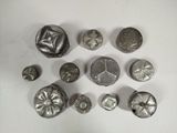 a lot of different metal buttons on a white surface
