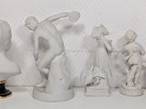 a lot of figurines that are sitting on a shelf