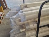 many rolls of white paper on a cart in a warehouse