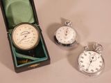two pocket watches and a pocket watch in a box